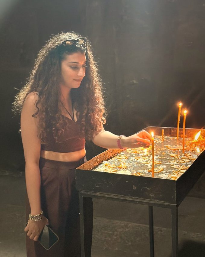 Radhika Talwar lighting candles in prayer